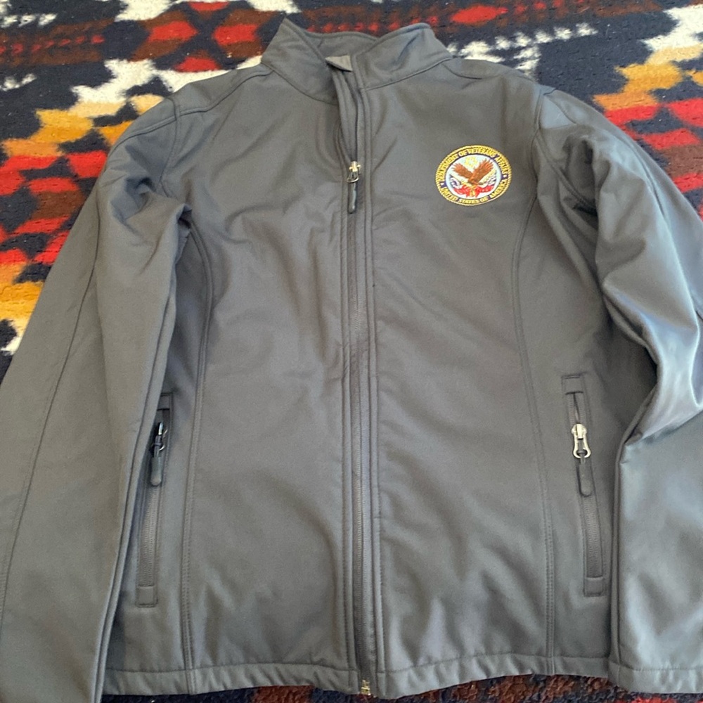 Grey zip up jacket.